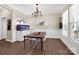 The dining room features wood flooring, a chandelier, and a large saltwater aquarium at 2210 Winding River Dr, Charlotte, NC 28214