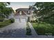 Charming two-story home with a well-manicured lawn, inviting entrance, and a spacious two-car garage at 2210 Winding River Dr, Charlotte, NC 28214
