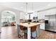 Bright kitchen featuring white cabinets, stainless steel appliances, and a stylish island with seating at 2210 Winding River Dr, Charlotte, NC 28214