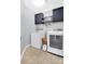 Modern laundry room features washer, dryer, and storage cabinets for supplies at 2210 Winding River Dr, Charlotte, NC 28214
