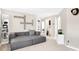 Inviting living room with modern gray sectional, neutral walls, carpet, and decorative wall art at 2210 Winding River Dr, Charlotte, NC 28214