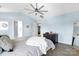 Spacious main bedroom featuring wood-look floors, lots of light, a ceiling fan, and neutral blue walls at 2210 Winding River Dr, Charlotte, NC 28214
