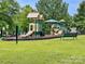 Community playground with modern equipment, benches, and plenty of open grass for play at 2210 Winding River Dr, Charlotte, NC 28214