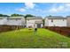Spacious backyard with a swing set, storage shed, wooden fence, and lush greenery, ideal for outdoor enjoyment at 2234 Dion Ave, Charlotte, NC 28212