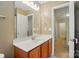Bright bathroom featuring a large mirror, vanity with sink and access to storage and other rooms at 2234 Dion Ave, Charlotte, NC 28212