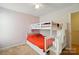 This bedroom features a cozy bunk bed with stairs and storage drawers at 2234 Dion Ave, Charlotte, NC 28212