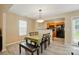 Dining area with a bench, table and chairs, lit by a modern light fixture with hardwood floors at 2234 Dion Ave, Charlotte, NC 28212