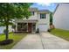 Charming home featuring light yellow siding, brick accents, blue shutters, and a well-maintained front yard at 2234 Dion Ave, Charlotte, NC 28212