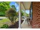 Charming front porch features brick accents, stylish chairs, and neat landscaping, creating a cozy outdoor space at 2234 Dion Ave, Charlotte, NC 28212