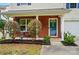 Inviting front porch with brick facade, cozy seating, and neat landscaping, offering a welcoming entrance at 2234 Dion Ave, Charlotte, NC 28212