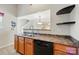 An open kitchen features wood cabinets and modern appliances and fixtures at 2234 Dion Ave, Charlotte, NC 28212
