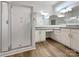 Bright bathroom features double vanity, granite countertops, a shower and wood flooring at 2312 Christensens Ct, Charlotte, NC 28270