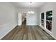 Bright dining room showcasing wood floors, chandelier, and access to kitchen at 2312 Christensens Ct, Charlotte, NC 28270