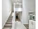 Inviting two-story foyer with staircase, tile flooring, and views into the living spaces at 2312 Christensens Ct, Charlotte, NC 28270