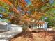 Charming single-story home with blue siding, a two-car garage, and a mature tree in the front yard at 2312 Christensens Ct, Charlotte, NC 28270