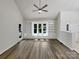 Bright living room featuring built-in shelving, large windows, vaulted ceiling and contemporary wood floors at 2312 Christensens Ct, Charlotte, NC 28270