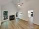 Open-concept living room with fireplace, wood floors, and ample natural light at 2312 Christensens Ct, Charlotte, NC 28270