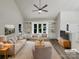 Bright living room featuring neutral decor, built-in shelving, and large windows showcasing the outdoor view at 2312 Christensens Ct, Charlotte, NC 28270