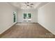 Spacious main bedroom showcasing tray ceiling and french doors to deck at 2312 Christensens Ct, Charlotte, NC 28270