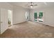 Spacious main bedroom with plush carpeting, ceiling fan, and access to private balcony at 2312 Christensens Ct, Charlotte, NC 28270