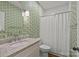 Stylish bathroom features a patterned wallpaper, granite countertop, and shower with white tile at 2315 Winthrop Ave, Charlotte, NC 28203
