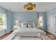 Light blue bedroom features large window, bench, lamps, and a decorative light fixture at 2315 Winthrop Ave, Charlotte, NC 28203
