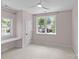 Bright, spacious bedroom with a ceiling fan, two windows, and neutral carpeting, ideal for comfort and style at 2315 Winthrop Ave, Charlotte, NC 28203