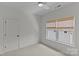 Inviting bedroom featuring a ceiling fan and dual windows with woven shades, providing ample natural light at 2315 Winthrop Ave, Charlotte, NC 28203