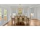 Bright dining room with wood floors, neutral furniture, modern chandelier, and white walls at 2315 Winthrop Ave, Charlotte, NC 28203