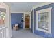 Close-up of the entryway, including a wooden door, and ample porch seating at 2315 Winthrop Ave, Charlotte, NC 28203