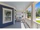 View of a relaxing front porch with a hanging swing and natural light at 2315 Winthrop Ave, Charlotte, NC 28203