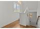 Well-lit hallway with hardwood floors and a staircase leading to upper level at 2315 Winthrop Ave, Charlotte, NC 28203