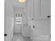 Efficient laundry room featuring modern appliances, ample cabinet storage, and stylish patterned flooring at 2315 Winthrop Ave, Charlotte, NC 28203
