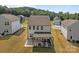 Aerial view of a house with a covered patio and a well-manicured yard at 3127 Pinehills Way, Mount Holly, NC 28120