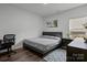 Cozy bedroom with hardwood floors, a gray bed frame, and a bright window at 3127 Pinehills Way, Mount Holly, NC 28120