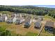 View of new homes in a suburban neighborhood with wooded backdrop at 3127 Pinehills Way, Mount Holly, NC 28120