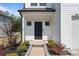 Inviting entrance showcasing a black front door, manicured landscaping, and a walkway at 3127 Pinehills Way, Mount Holly, NC 28120