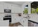 Bright kitchen showcasing white cabinetry, modern appliances, and stylish backsplash at 3127 Pinehills Way, Mount Holly, NC 28120