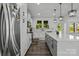 Well-equipped kitchen with stainless steel appliances, a center island, and a view to the backyard at 3127 Pinehills Way, Mount Holly, NC 28120
