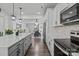 Open-concept kitchen featuring a large island, stainless appliances, and hardwood flooring at 3127 Pinehills Way, Mount Holly, NC 28120