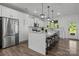 Spacious kitchen boasting white cabinets, stainless steel appliances, and a large center island at 3127 Pinehills Way, Mount Holly, NC 28120