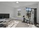 Bright office space with large windows, a modern desk, and exercise equipment at 3127 Pinehills Way, Mount Holly, NC 28120