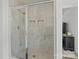 Modern shower with elegant marble walls and built-in shelving at 3127 Pinehills Way, Mount Holly, NC 28120