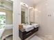 Contemporary bathroom with dual sinks, modern lighting, and direct access to the Primary bedroom at 314 Viburnum Way Ct, Charlotte, NC 28208