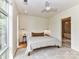 Bright bedroom featuring a ceiling fan, neutral tones, large window, and an ensuite bathroom with tub at 314 Viburnum Way Ct, Charlotte, NC 28208