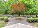 Inviting courtyard featuring a beautiful tree, benches, and manicured hedges for relaxation at 314 Viburnum Way Ct, Charlotte, NC 28208