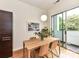 Bright dining room with a modern table, chairs, light fixture and sliding door to balcony at 314 Viburnum Way Ct, Charlotte, NC 28208
