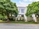 Modern home exterior surrounded by lush greenery and mature trees, creating a serene setting at 314 Viburnum Way Ct, Charlotte, NC 28208