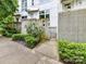 Modern home exterior with a concrete fence, manicured landscaping, and a gated walkway at 314 Viburnum Way Ct, Charlotte, NC 28208