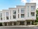Modern townhome featuring a white exterior, covered parking, and contemporary design at 314 Viburnum Way Ct, Charlotte, NC 28208